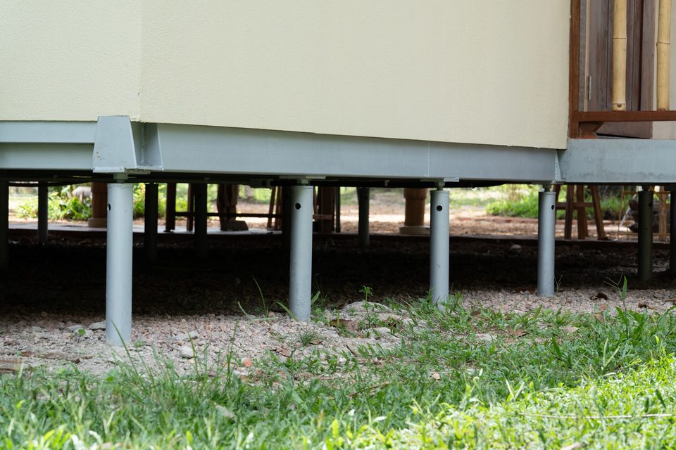 Slender steel micropiles carrying the building above the untouched ground