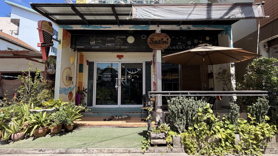 The original Satimi ice cream shop, its painted front and parasol on the street